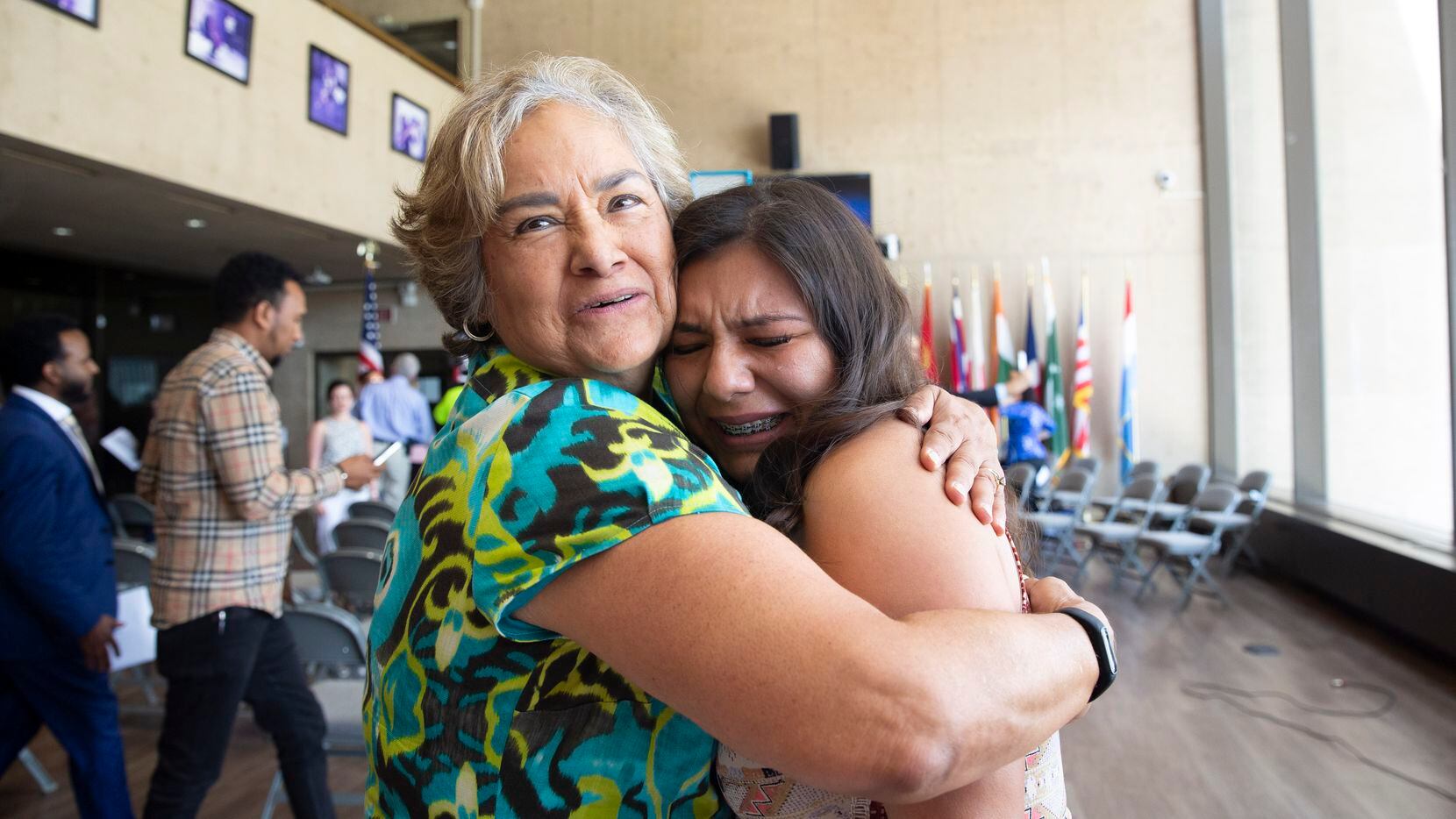 Rosa Hernandez-Razo, right, is embraced by Sarah Saldana, former Director of the U.S....