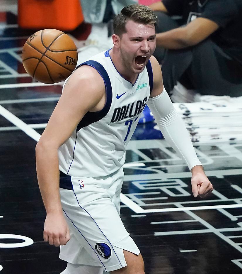 Dallas Mavericks guard Luka Doncic (77) celebrates after dunking the ball past LA Clippers forward Marcus Morris Sr. during the first half of an NBA playoff basketball game at Staples Center on Tuesday, May 25, 2021, in Los Angeles.