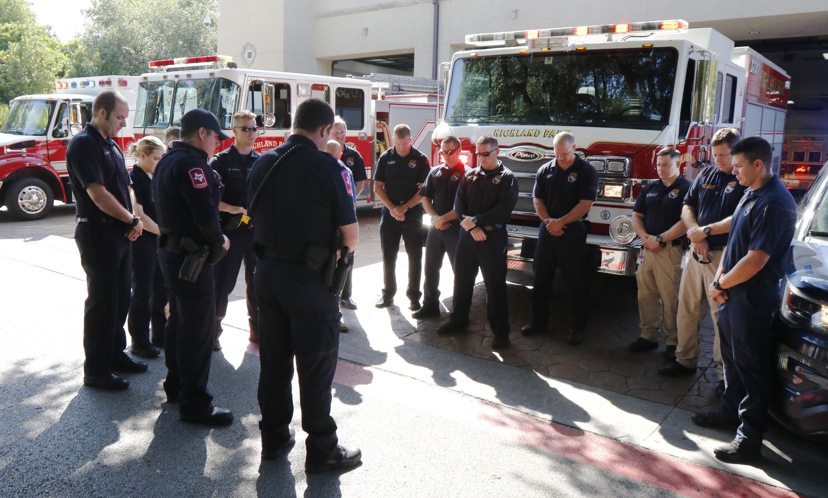 Officers with the Highland Park Public Safety Department pay respects on Friday, July 7,...