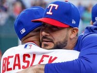 Texas Rangers starting pitcher Martin Perez (54) hugs Texas Rangers interim manager Tony...