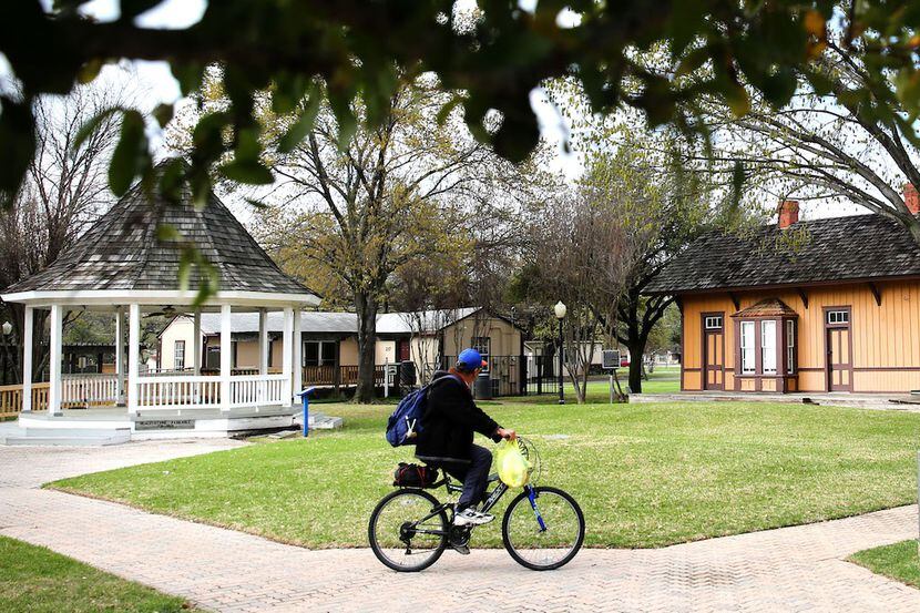 Kenny Smith rides his bike through Heritage Park in Irving.