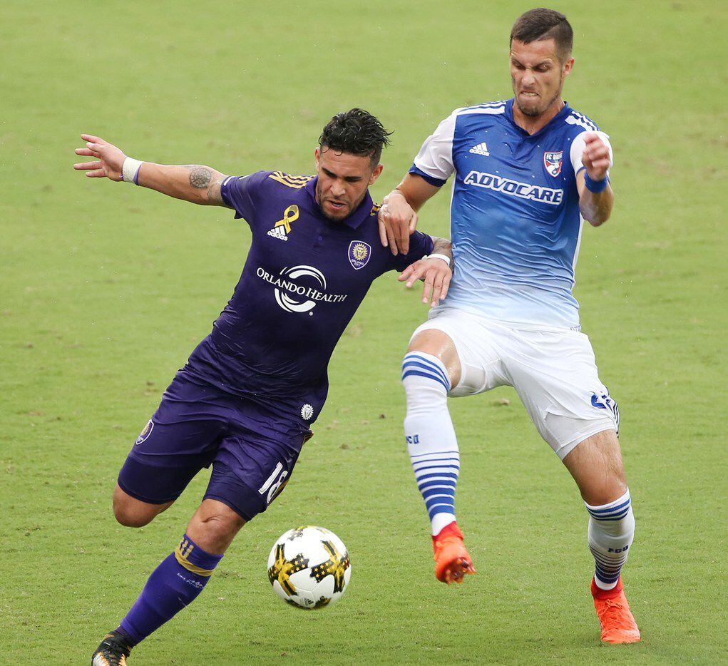 Orlando City's Dom Dwyer, left, and FC Dallas' Matt Hedges battle for the ball at Orlando City Stadium on Saturday, Sept. 30, 2017, in Orlando, Fla. The game ened in a scoreless draw. (Stephen M. Dowell/Orlando Sentinel/TNS)