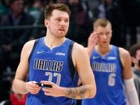 Dallas Mavericks guard Luka Doncic (77) adjusts the bandage on his index finger during the first half against the Phoenix Suns at the American Airlines Center in Dallas, January 20, 2022. 