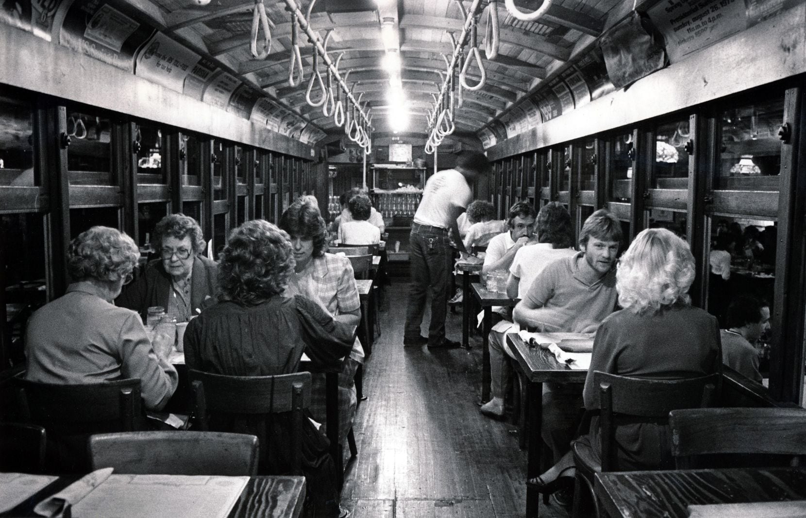 Diners eat inside the trolley at the Spaghetti Warehouse in Dallas' West End.