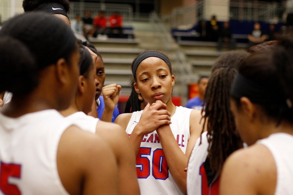 Duncanville forward Zaria Rufus and her teammates listen to a postgame talk after a game in...
