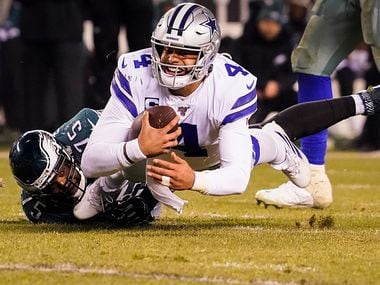 Dallas Cowboys quarterback Dak Prescott (4) is sacked by Philadelphia Eagles defensive end Vinny Curry (75) during the second half of an NFL football game at Lincoln Financial Field on Sunday, Dec. 22, 2019, in Philadelphia.