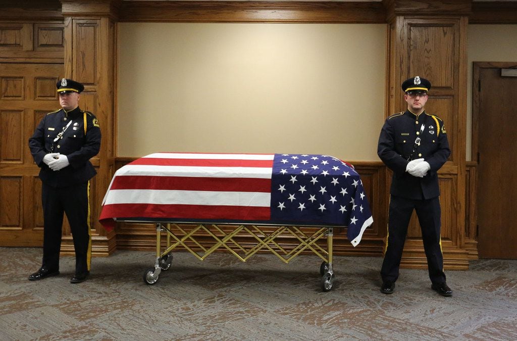 An honor guard stays with the body of Officer Rogelio Santander at Lake Pointe Church in...