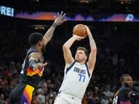 Dallas Mavericks guard Luka Doncic (77) shoots a 3-pointer over Phoenix Suns center Deandre...