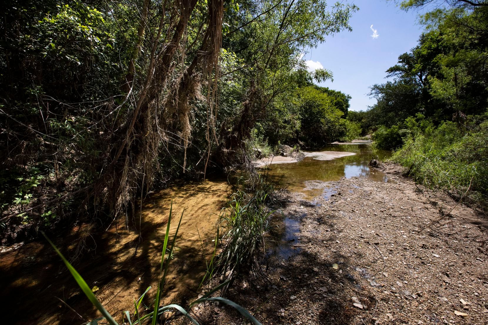 This sandy creek bed from the main road leads toward the home where Christopher Allen...