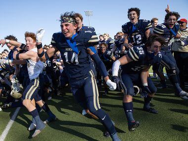 Austin Regents players celebrate after winning a TAPPS Division II state championship game...