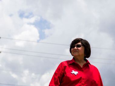 In this photo taken May 22, 2018, gubernatorial candidate and former Dallas County Sheriff Lupe Valdez waits to greet voters outside Renner Frankford Branch Library in Dallas.  