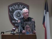 Burleson police Chief Billy Cordell holds up a photo of Kathryn Bryan, 64, during a news...