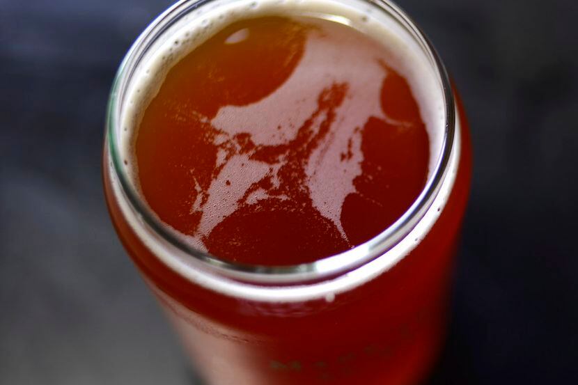 A freshly poured glass of beer at a tasting event