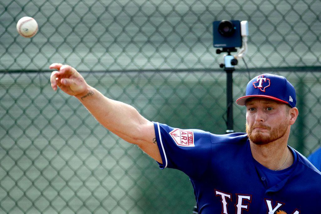 Texas Rangers pitcher Shelby Miller throws during spring training baseball practice Friday,...