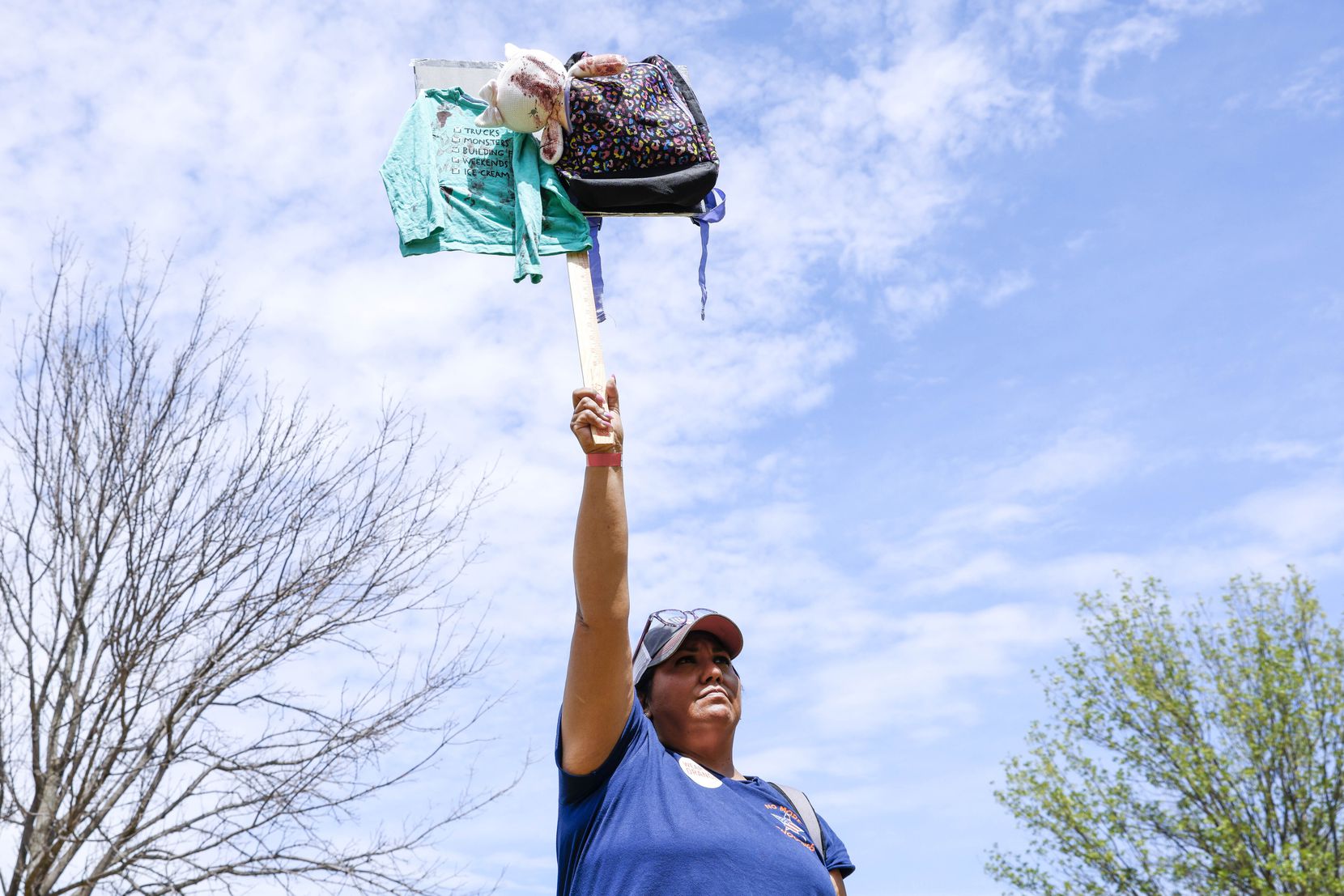 Bobbie Jo Hall of Fort Worth, holds a symbolic sign with school bag, protesting against gun...