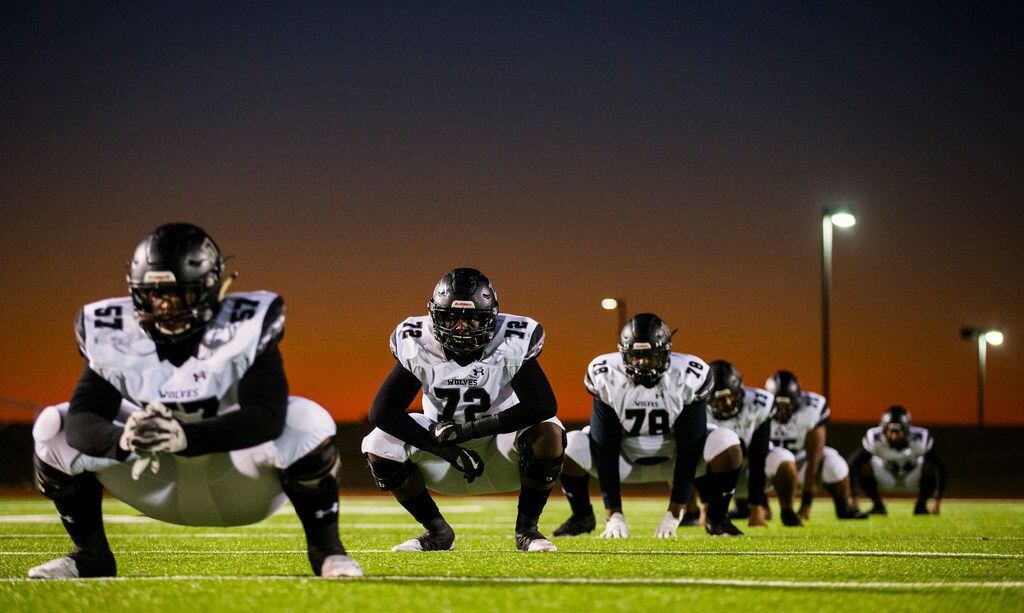 Mansfield Timberview football players warm up before a UIL Class 5A Division I first-round...