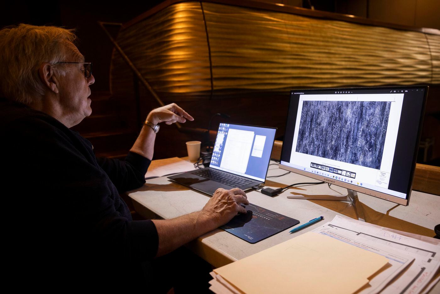 Technical consultant Drew Field looks over a design that set and projection designer Erhard...