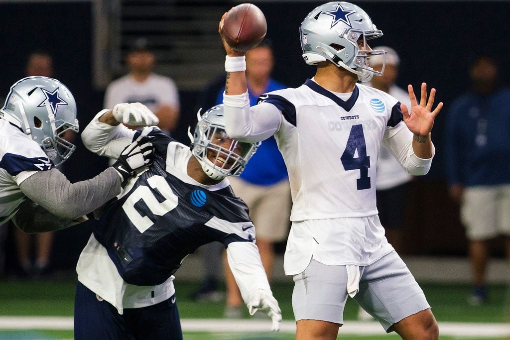 Dallas Cowboys quarterback Dak Prescott (4) throws a pass under pressure from defensive end Dorance Armstrong (92) during a team OTA practice at The Star on Wednesday, June 5, 2019, in Frisco. (Smiley N. Pool/The Dallas Morning News)
