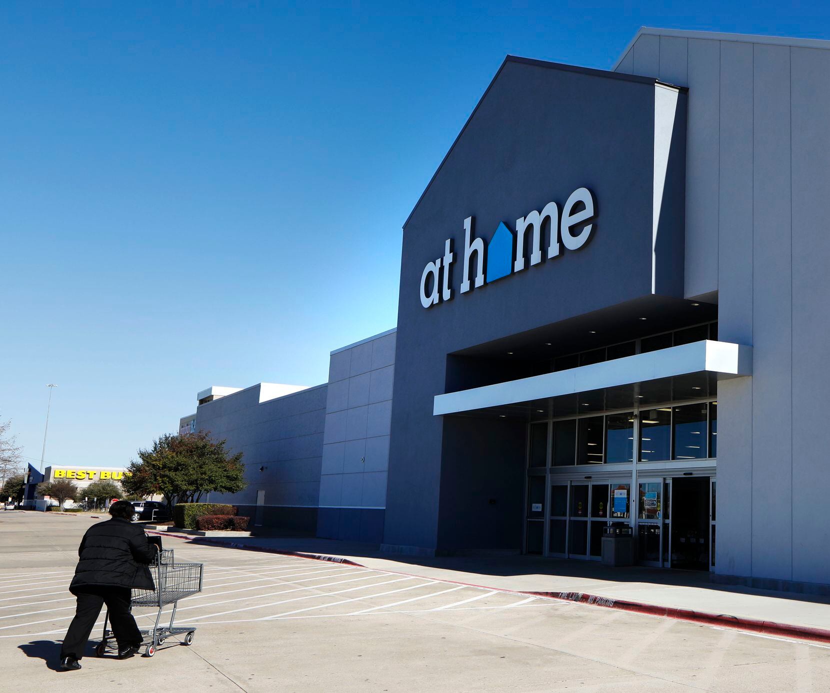 A shopper walks towards an At Home store in Plano. 