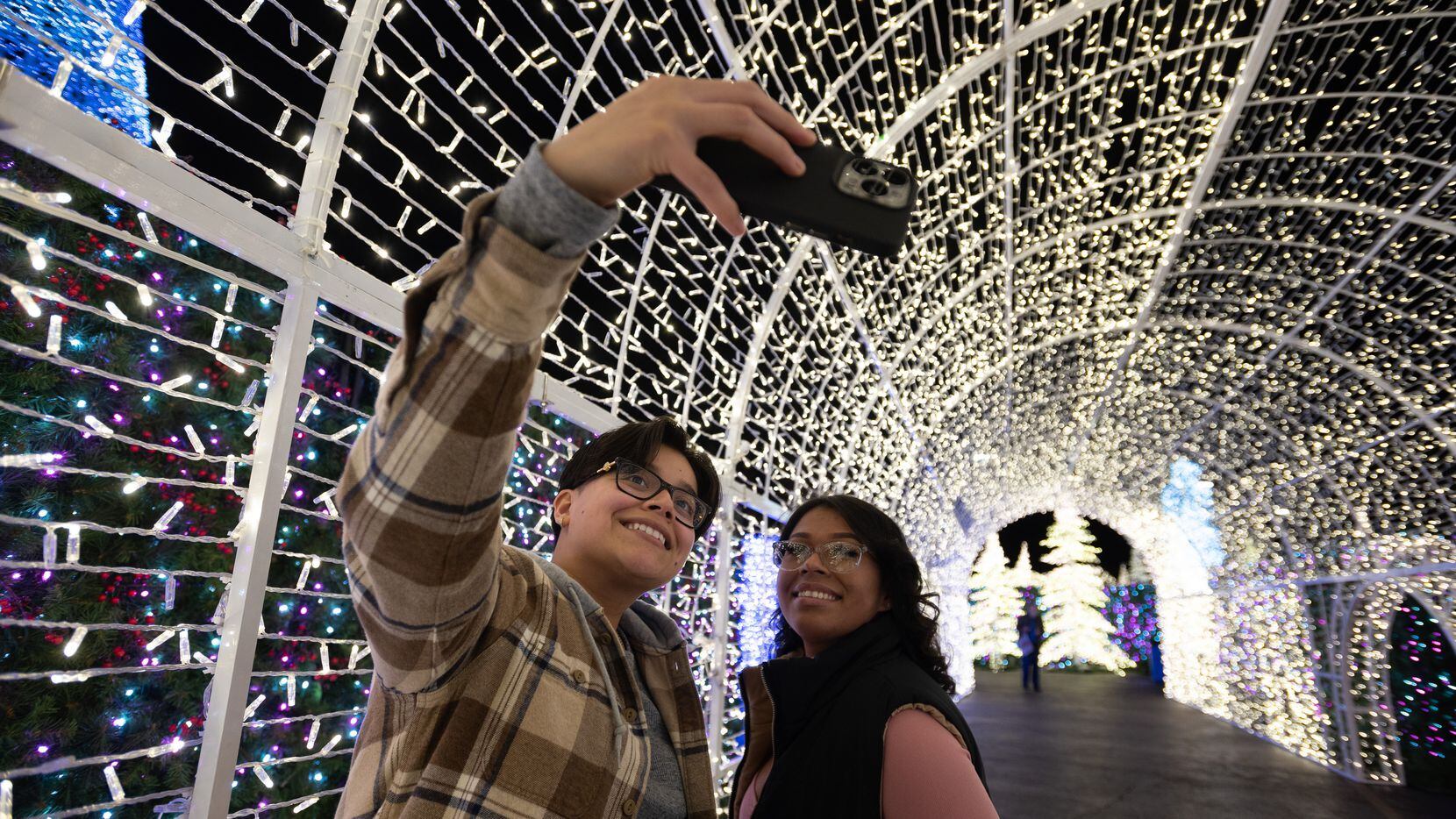 Joanne Benitez, 23, left, and Maria Reboyedo, 22, interact inside a light maze during the...
