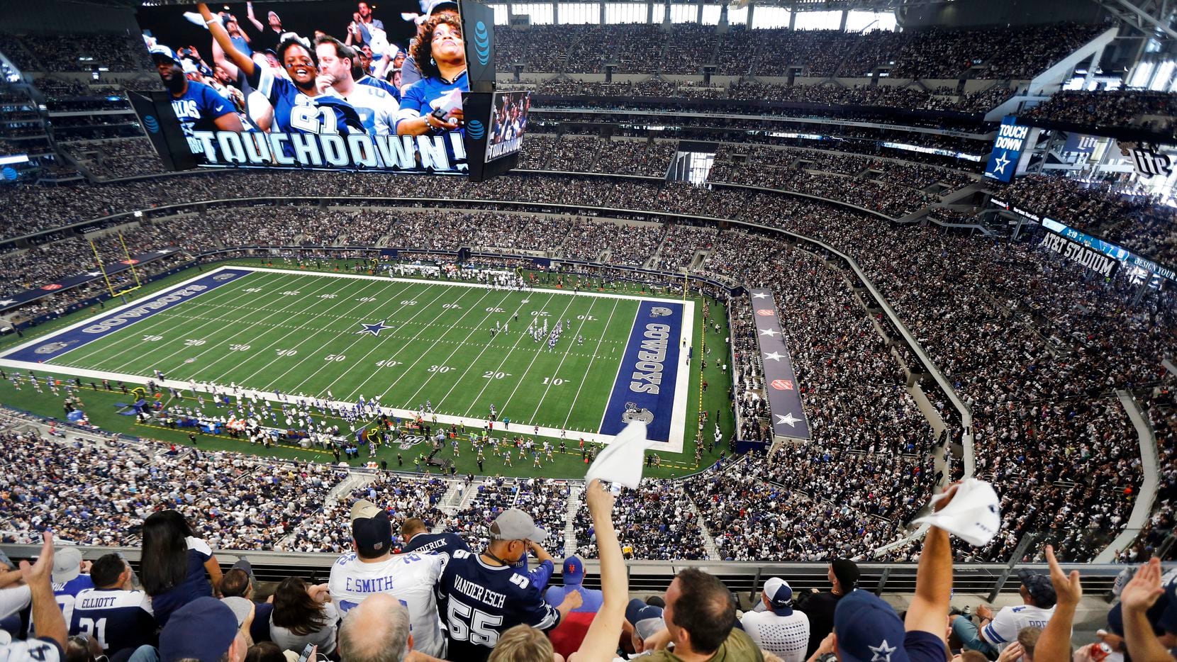 Fans are displayed on the giant overhead video screen as Dallas Cowboys fans cheer tight end Blake Jarwin's first quarter touchdown against the New York Giants at AT&T Stadium in Arlington, Texas, Sunday, September 8, 2019.