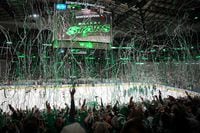 Confetti falls as Dallas Stars players and fans celebrate after a 2-1 victory over the Vegas...