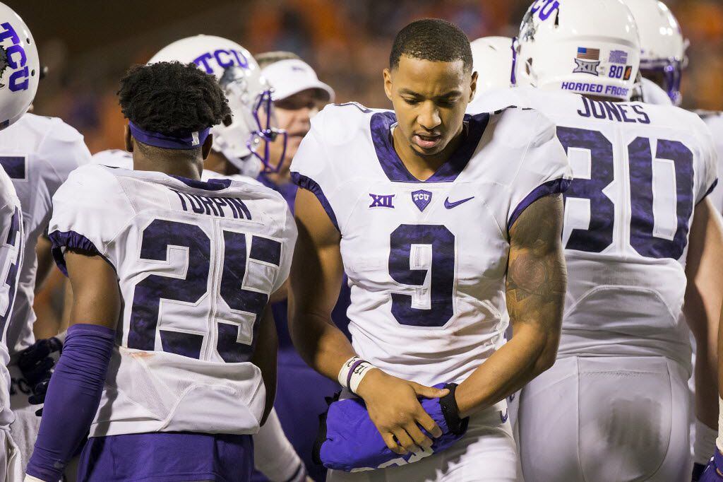 TCU wide receiver Josh Doctson clutches his left hand during a timeout in the fourth quarter...