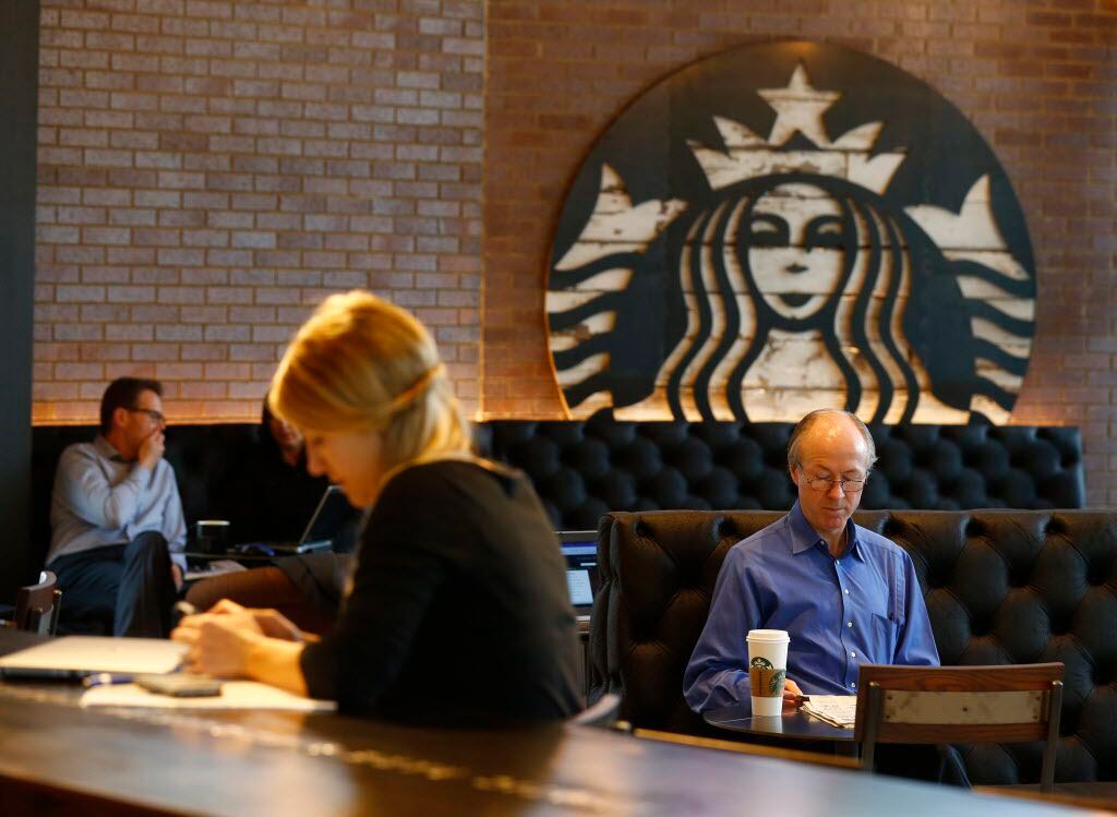 Natalie Ilseng (left) and Mike Hendrix sit at a new Starbucks in the Shops at Park Lane,...