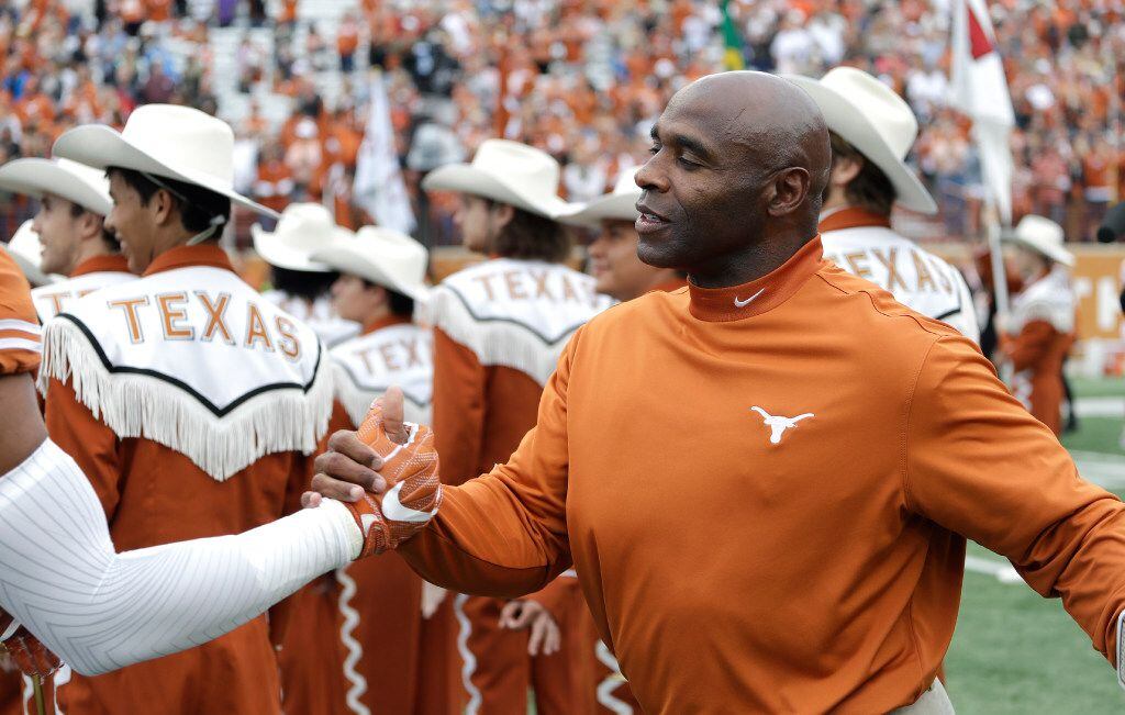 Texas head coach Charlie Strong greets his senior players before an NCAA college football...