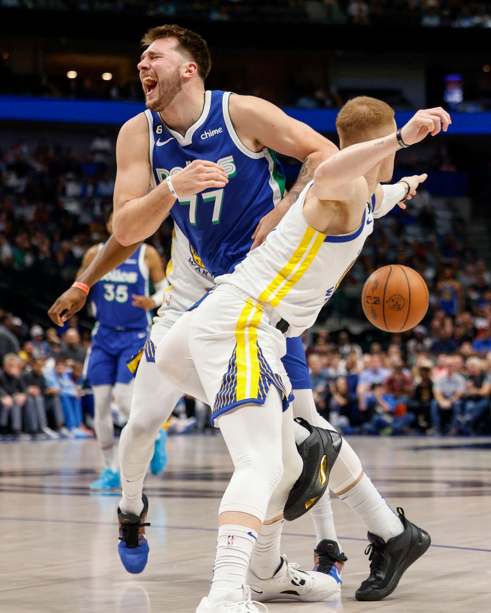 Dallas Mavericks guard Luka Doncic (77) collides with Golden State Warriors guard Donte...