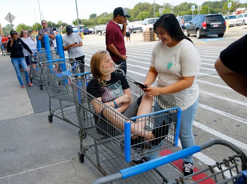 Jessica Puffen, 16, waited in a shopping cart along with her friend Emily Gomez, 17,  in a...