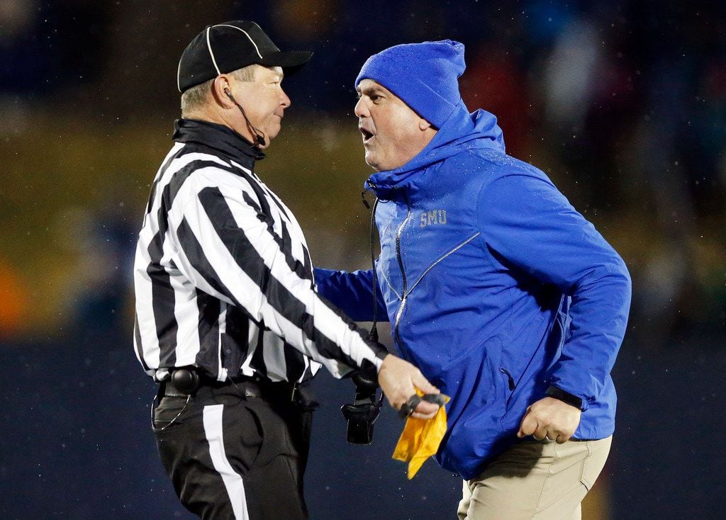 Southern Methodist Mustangs head coach Sonny Dikes yells in the face of an official, who...