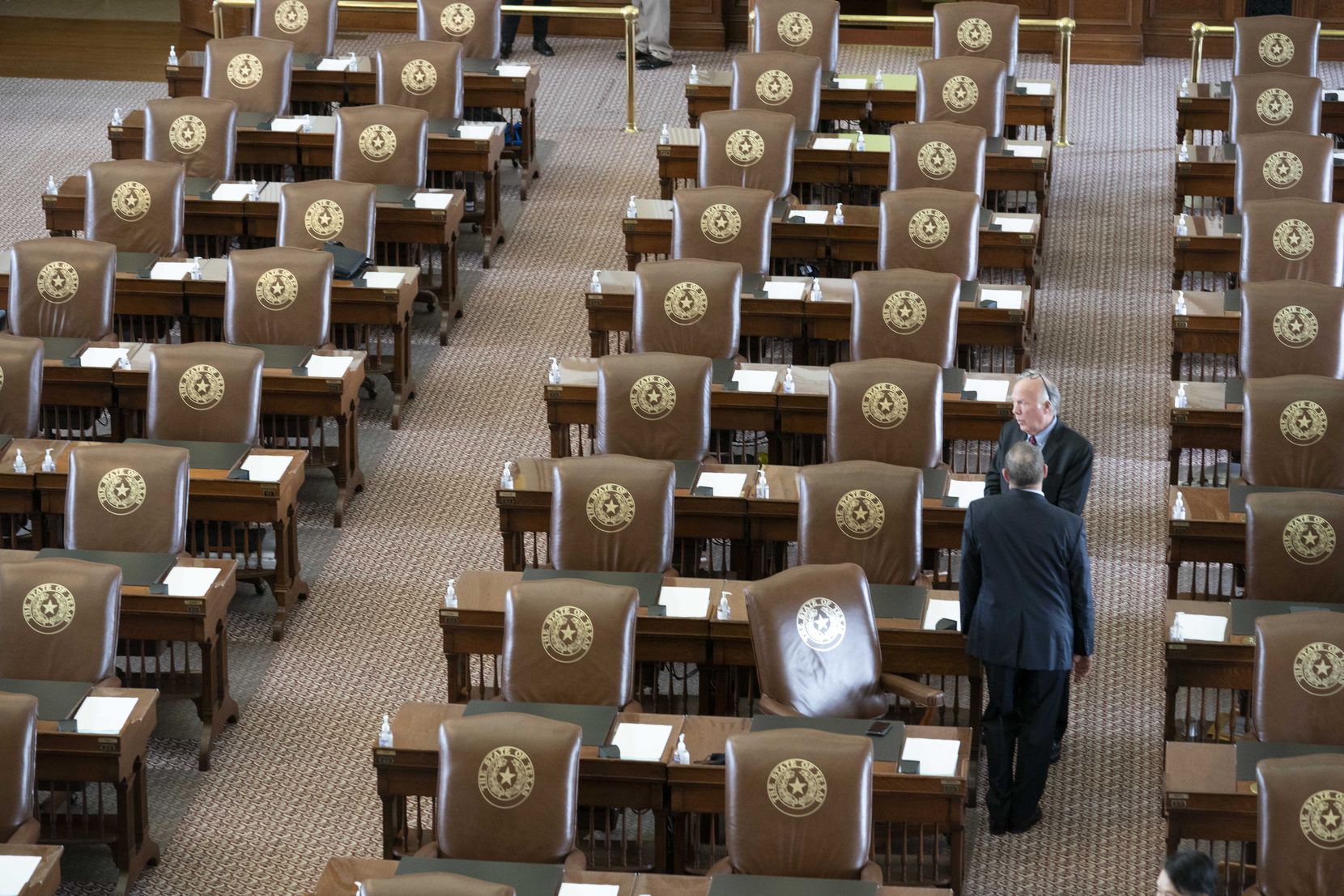 State Rep. Todd Hunter, R-Corpus Christi, talks with a colleague as the House gathers late for Sine Die on the final day of the 87th Texas Legislature. 