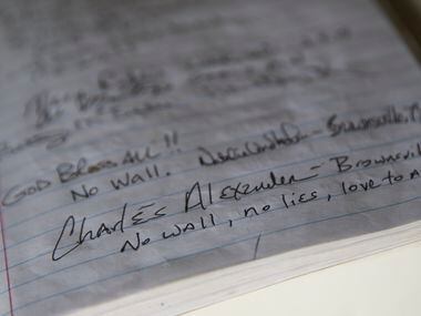 Notes from visitors to La Lomita chapel are seen in a notebook.