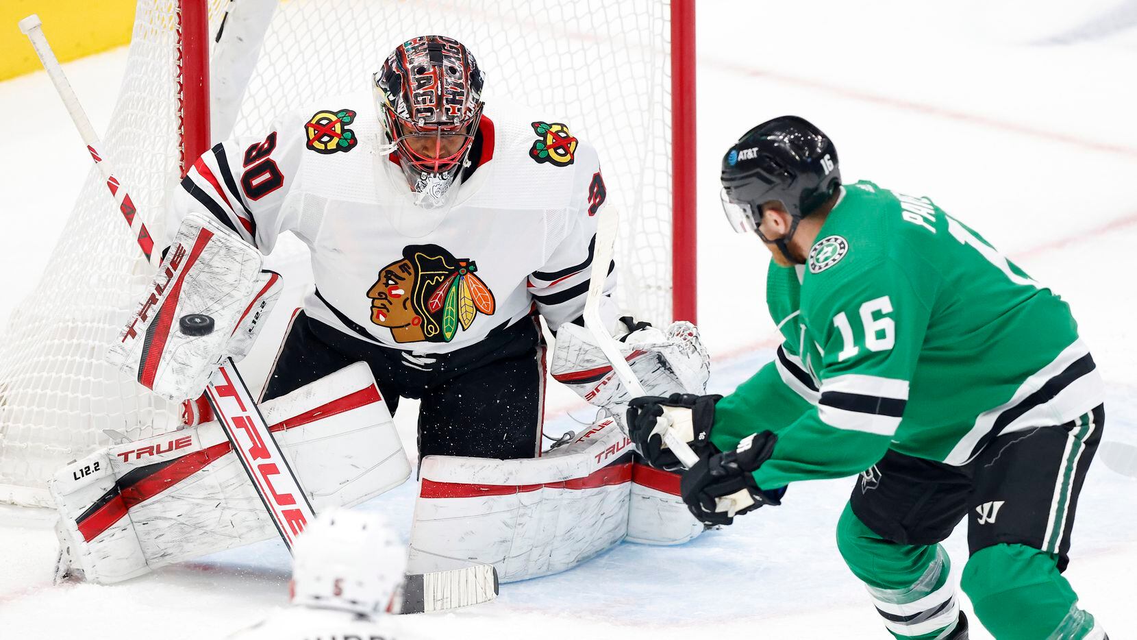 Dallas Stars center Joe Pavelski (16 backhands a shot which is blocked by Chicago Blackhawks...