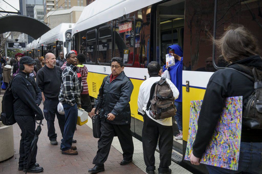 Commuters board a DART train in downtown Dallas.