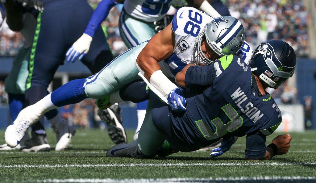 Dallas Cowboys defensive end Tyrone Crawford (98) hits Seattle Seahawks quarterback Russell...