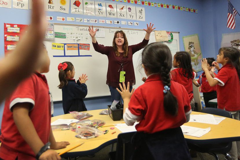 Kindergarten teacher Myka Moseley works with her students during morning class at the...
