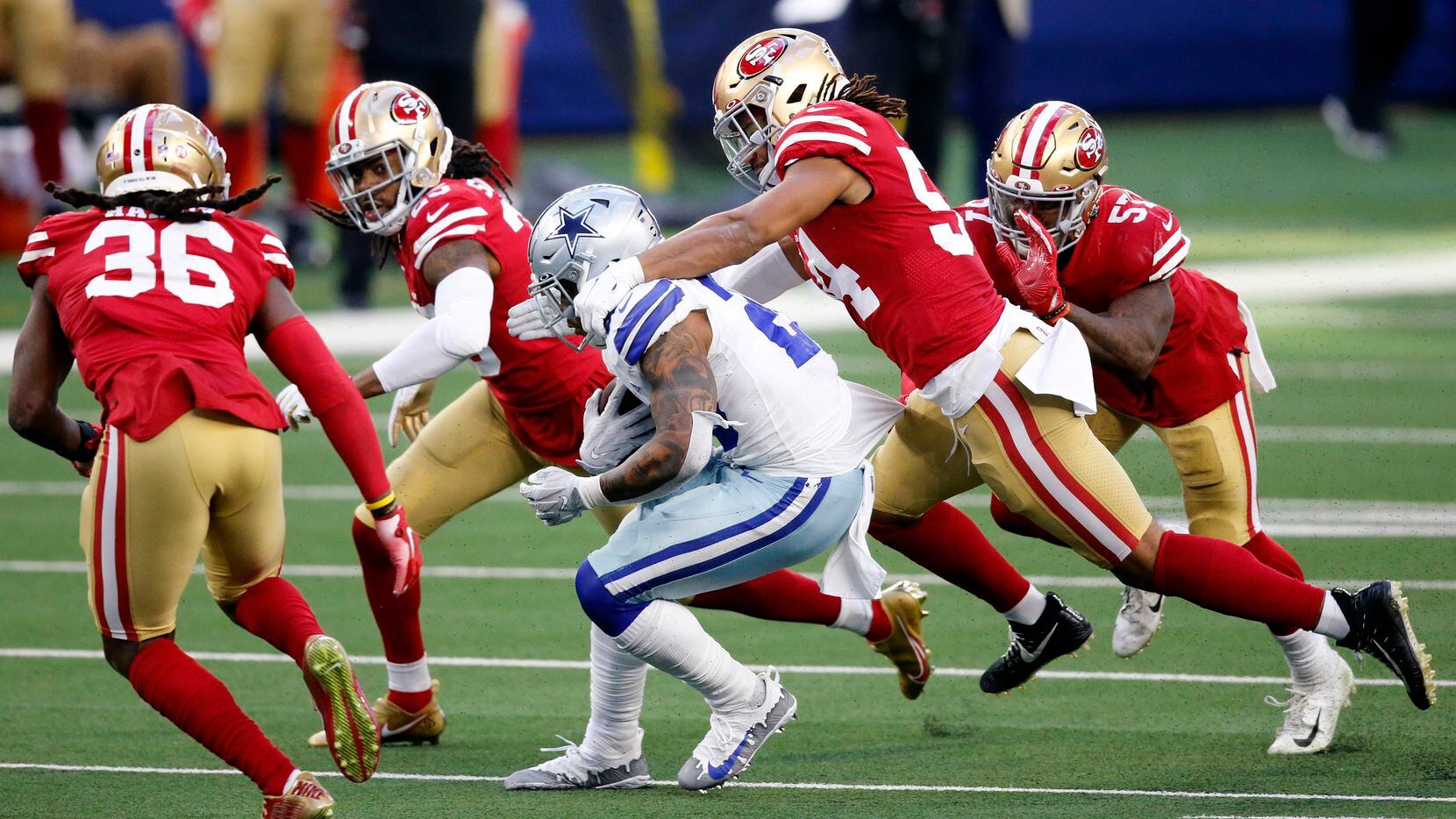 Dallas Cowboys running back Tony Pollard (20) broke away from several San Francisco 49ers defenders, including middle linebacker Fred Warner (54), for a fourth quarter touchdown at AT&T Stadium in Arlington, Texas, Sunday, December 20, 2020.