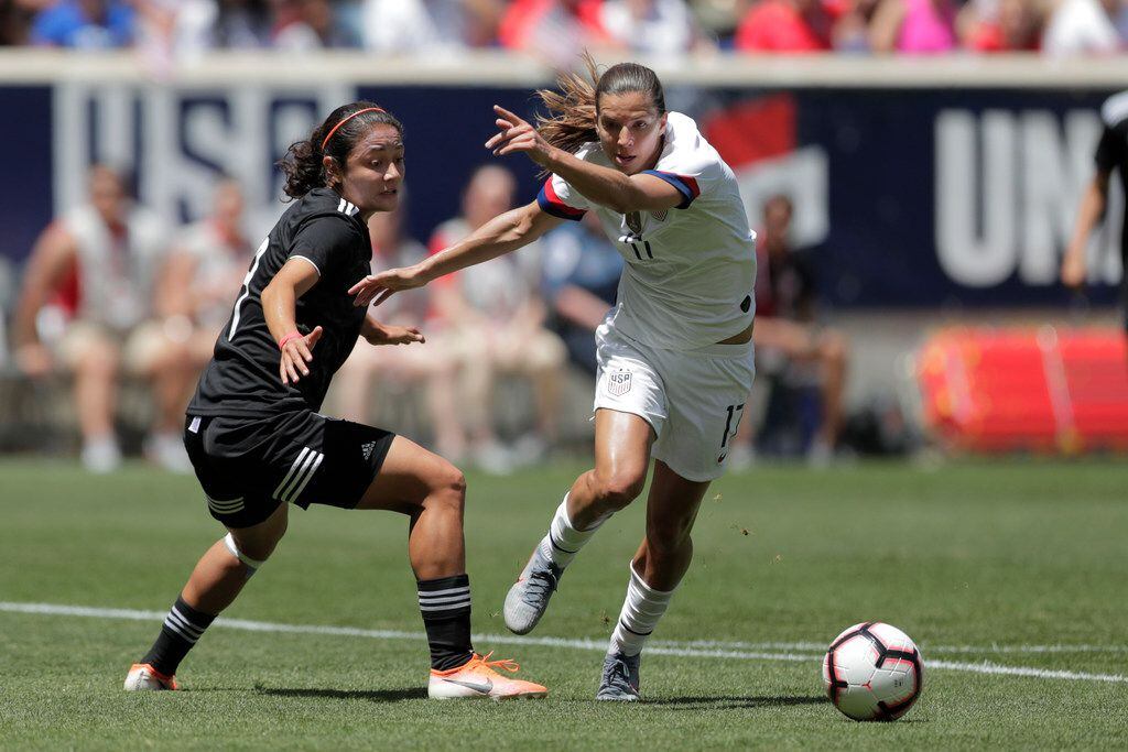 United States forward Tobin Heath, right, steals the ball from Mexico defender Rebeca Bernal...