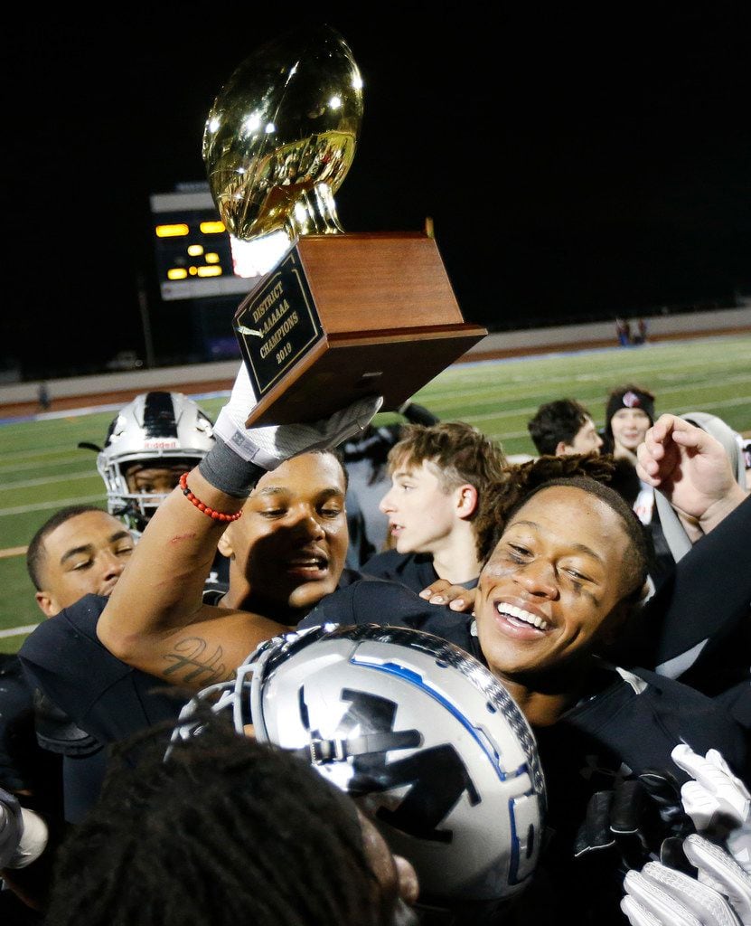 Martin linebacker Morice Blackwell (center) celebrates their District 4-6A title with...