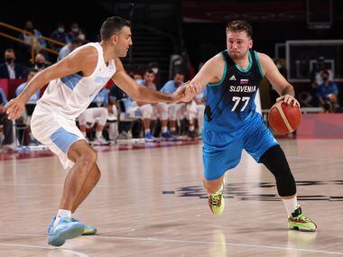 Slovenia’s Luka Doncic (77) drives on Argentina’s Luis Scola (4) in the first half of play...