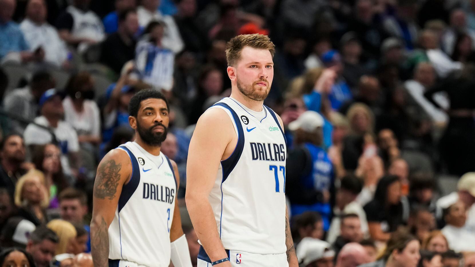 Dallas Mavericks guard Luka Doncic (77) and guard Kyrie Irving (2) wait for play to begin...