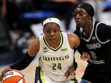 Dallas Wings guard Arike Ogunbowale (24) drives past the defense of the Chicago Sky guard...