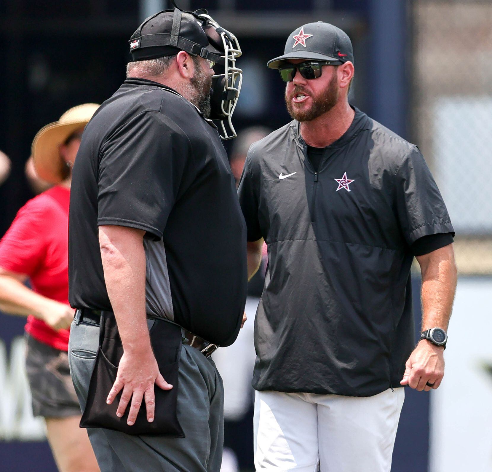 Coppell head coach Will Lowrance Jr has a few choice words to the home plate umpire during...