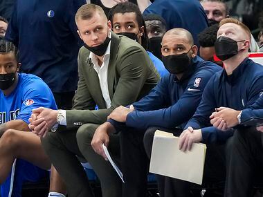 Dallas Mavericks center Kristaps Porzingis watches from the bench during the second half of an NBA basketball game against the Sacramento Kings at American Airlines Center on Sunday, Oct. 31, 2021, in Dallas. 