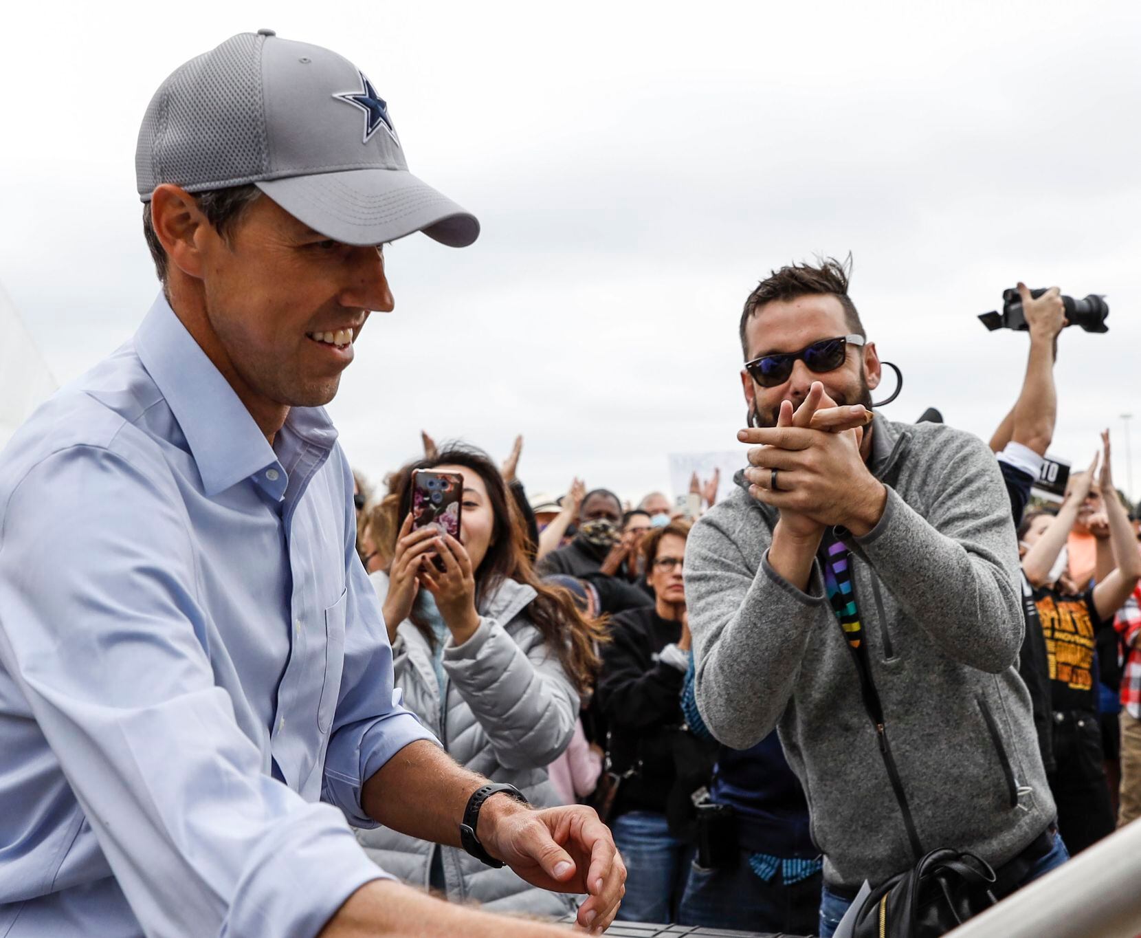 Beto O'Rourke runs onto the stage past supporters during a rally in Dallas on Sunday, Nov....
