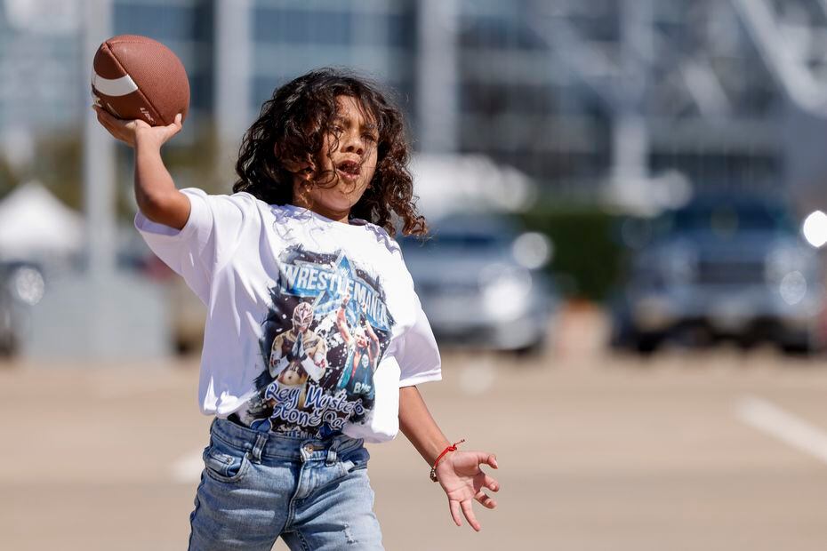 Jet Salazar, 7, throws a football with his dad before WrestleMania 38.