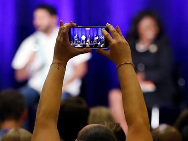 A delegate records a video of U.S. House Texas District candidates on a panel discussion at...