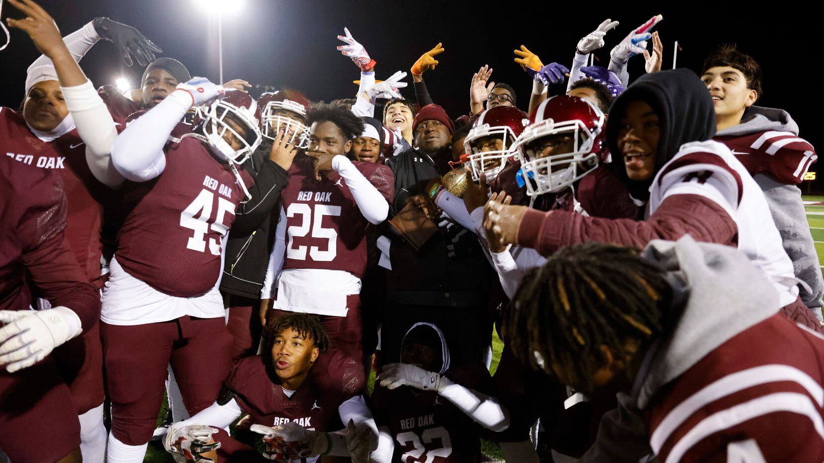 Red Oak High players celebrates their win against Denton High during a football game at...